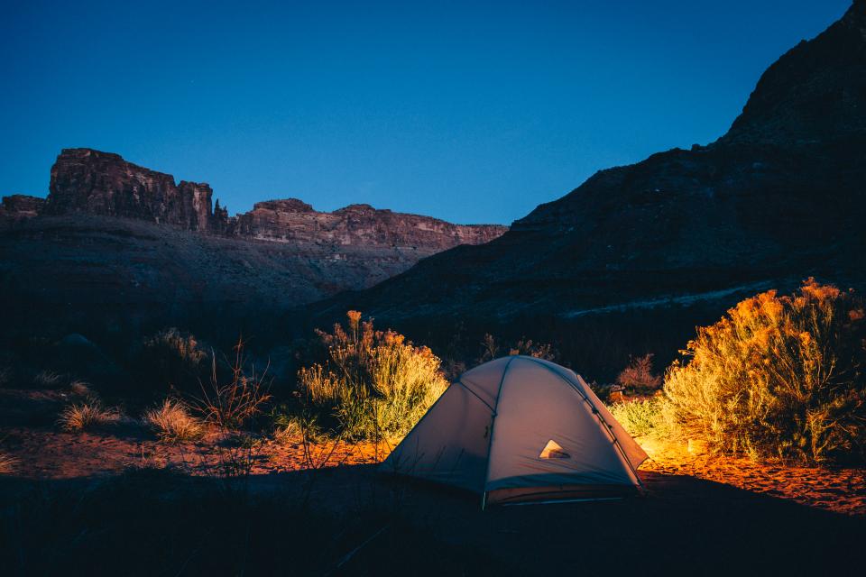 Tent at blue hour in a desert canyon